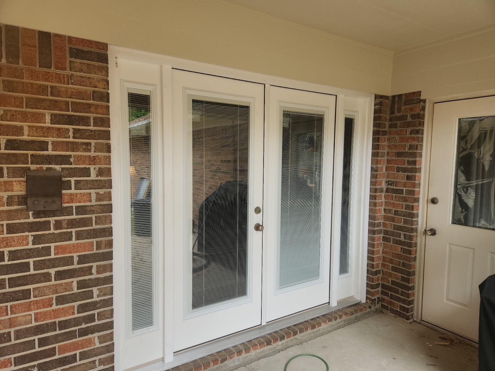 Exterior doors installed on a brick home