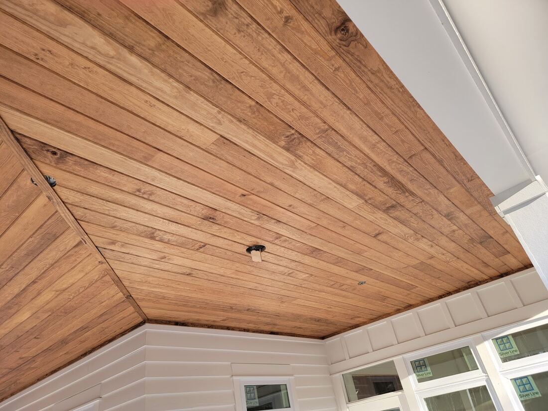 Finished wood ceiling with detailed perimeter trim