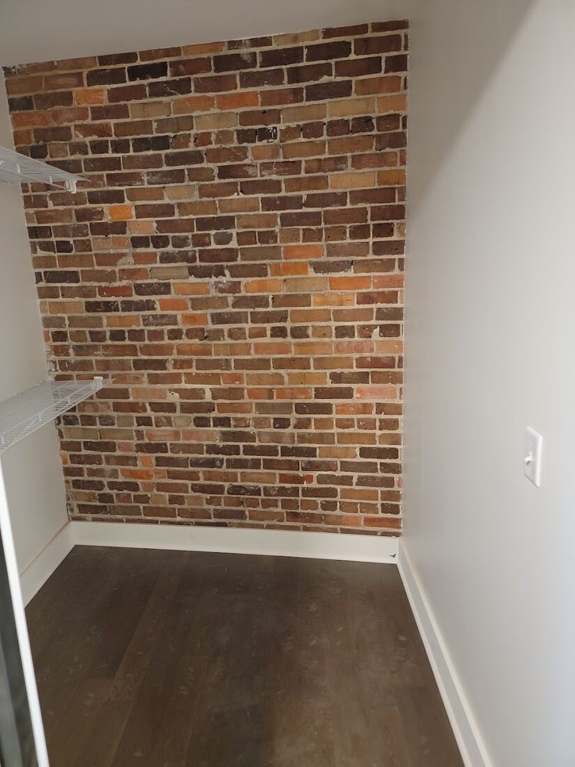 Interior brick accent wall and finished flooring