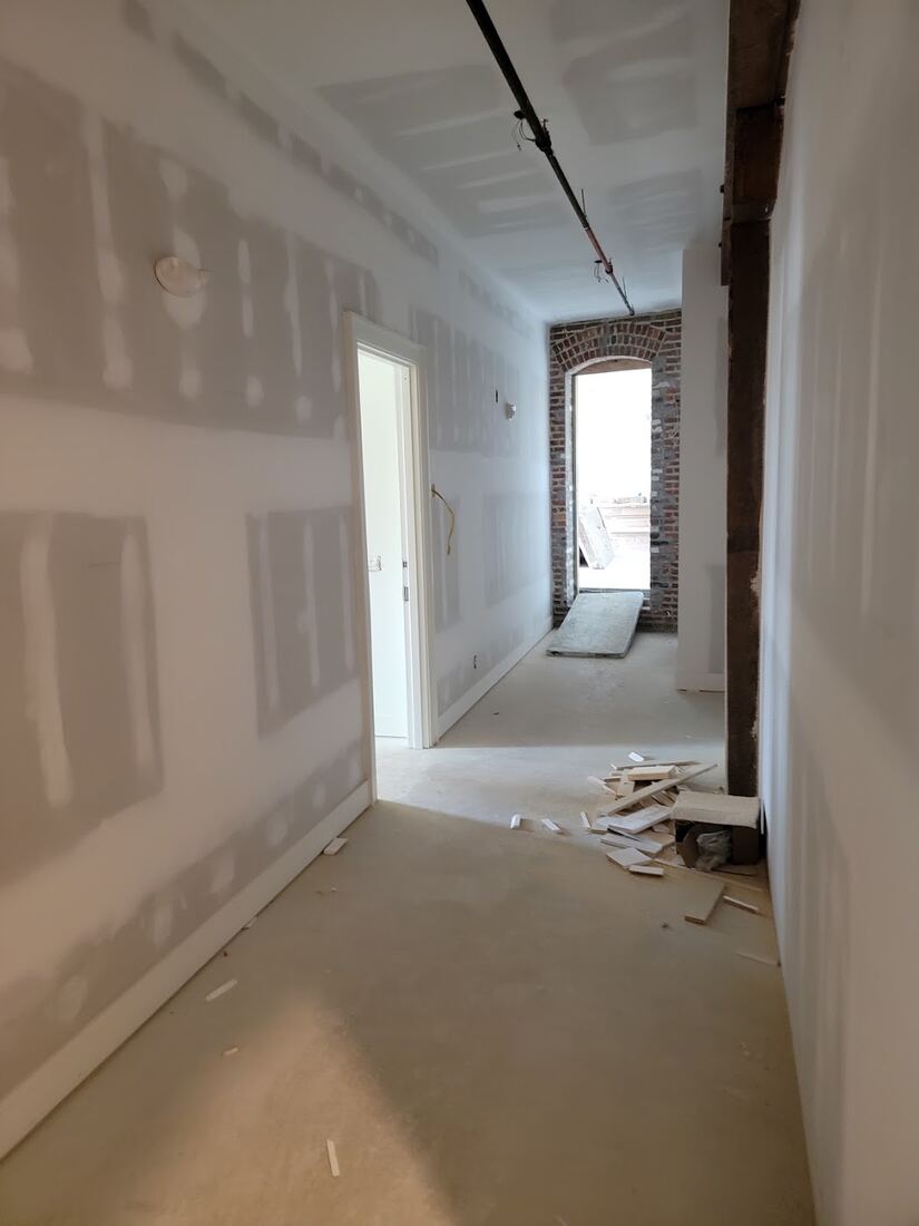 Interior hallway with finished door and wall trim